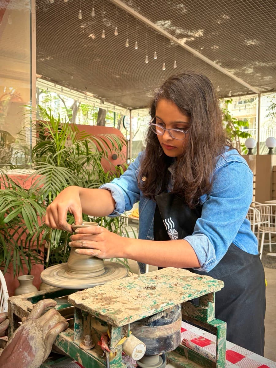 Aditi working on a pottery wheel